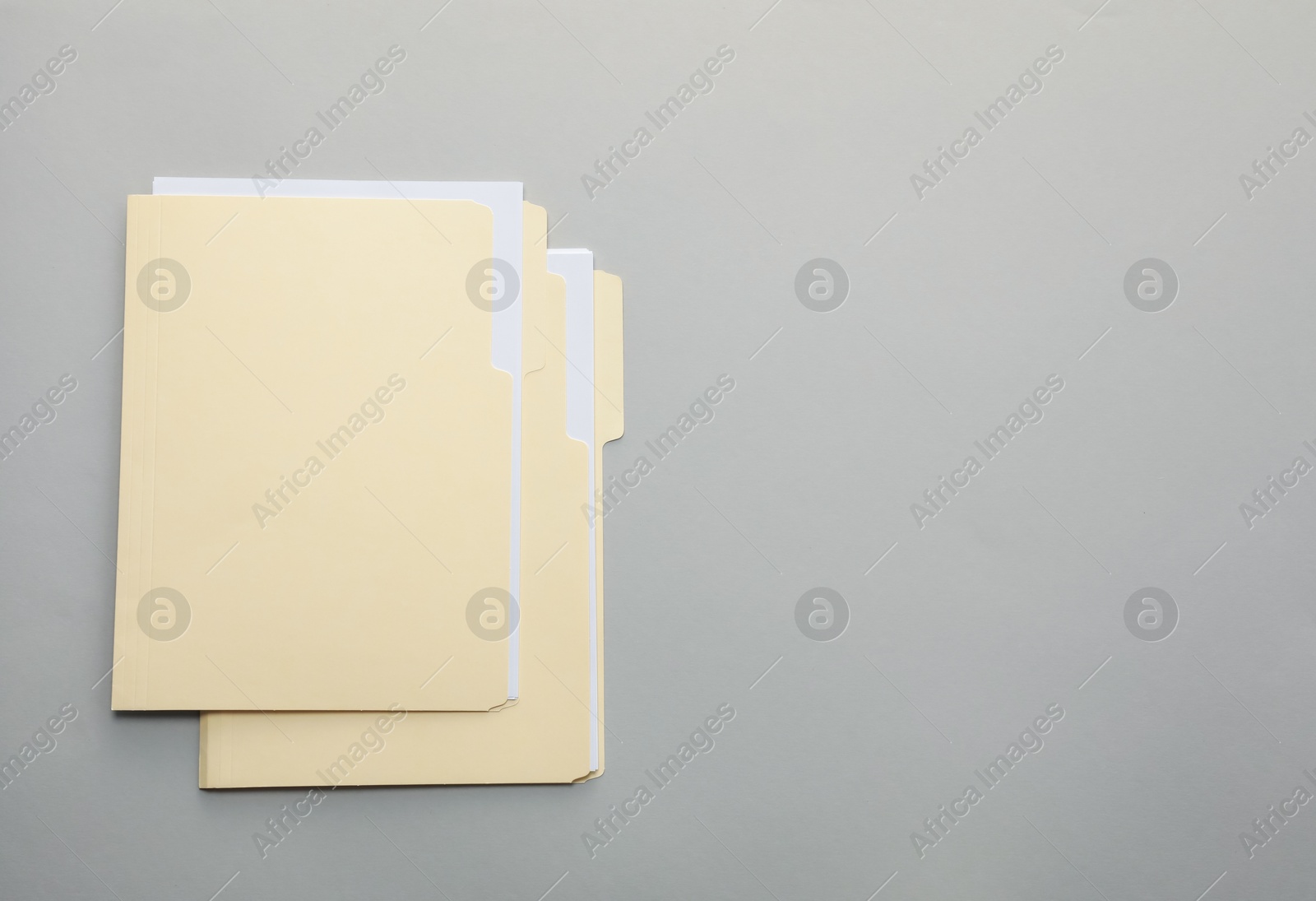 File folders with papers on gray background, top view. Space for text Photo of File folders with papers on gray background, top view. Space for text