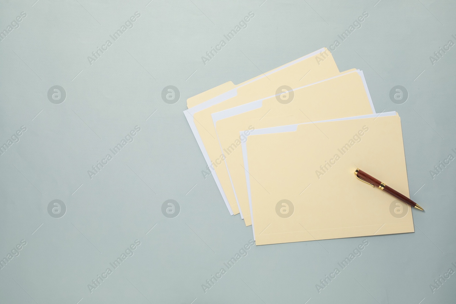 File folders with papers and pen on gray background, top view. Space for text Photo of File folders with papers and pen on gray background, top view. Space for text