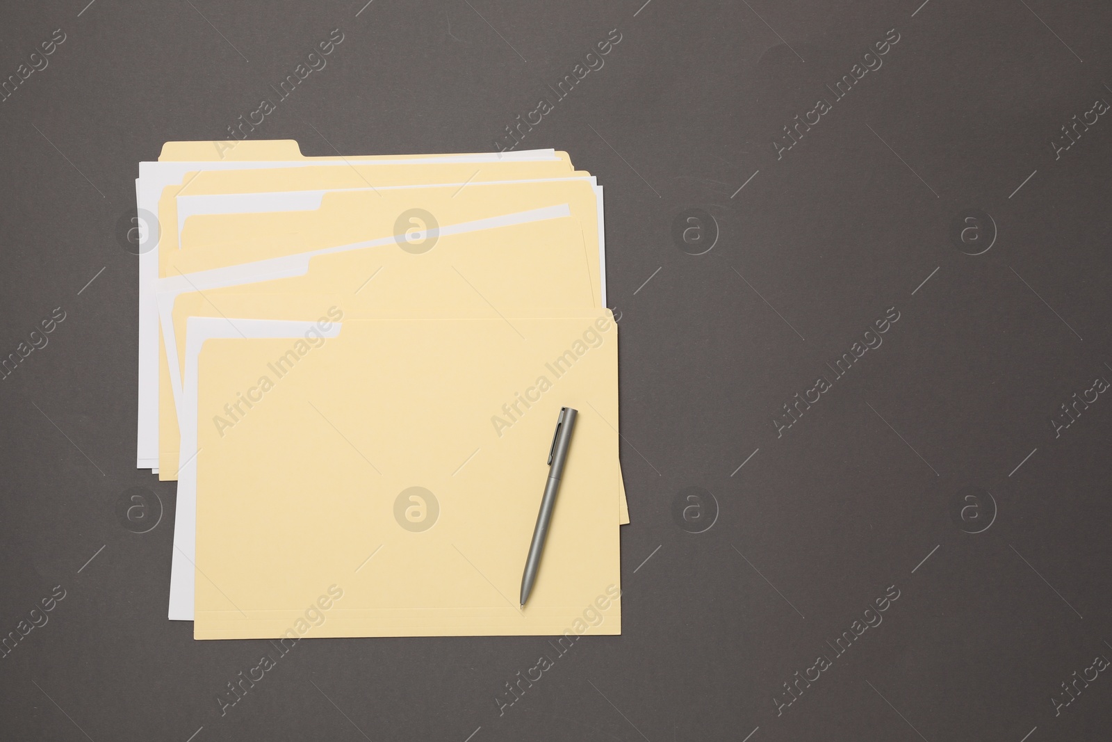 File folders with papers and pen on gray background, top view. Space for text Photo of File folders with papers and pen on gray background, top view. Space for text