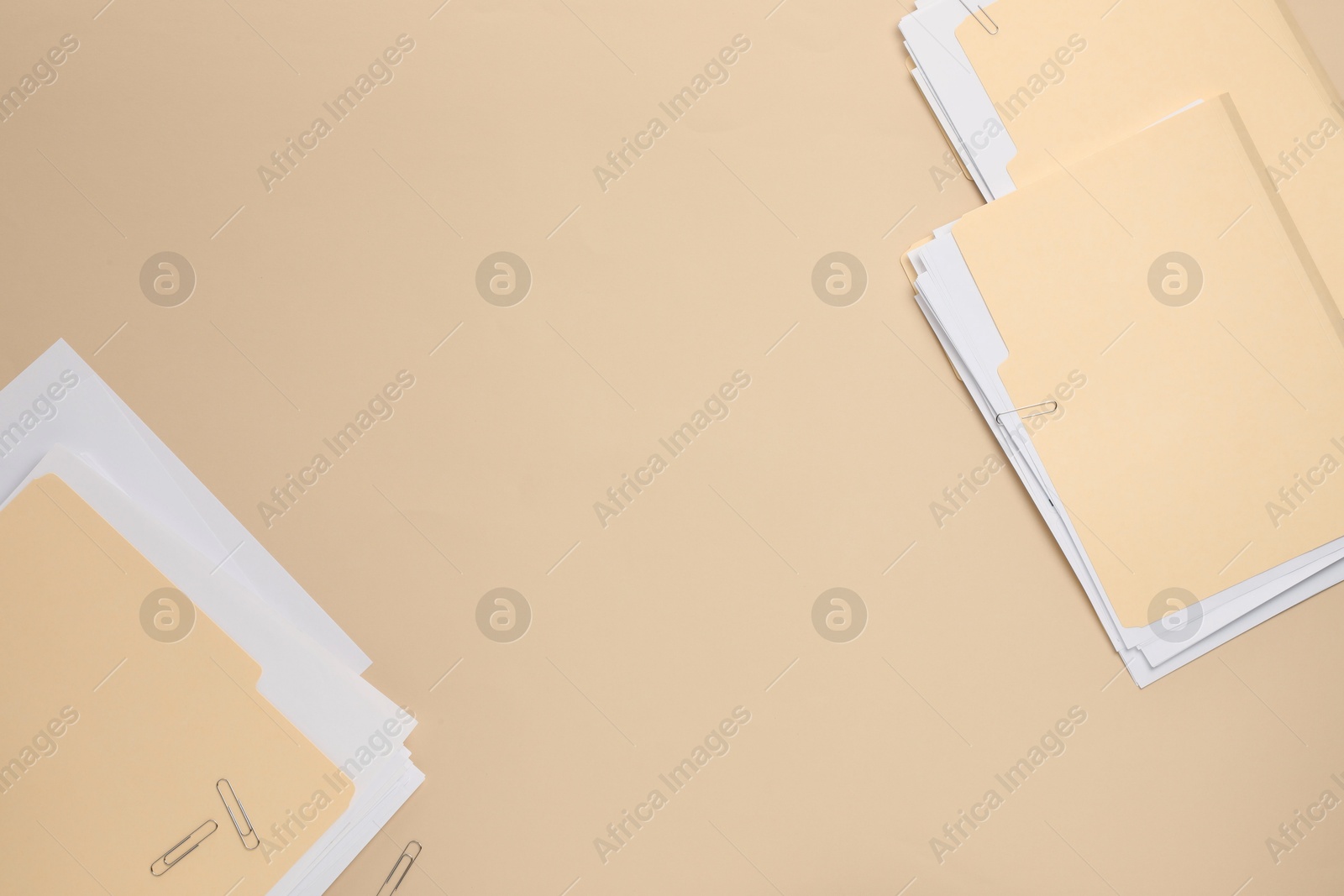 File folders with papers on beige background, flat lay. Space for text Photo of File folders with papers on beige background, flat lay. Space for text