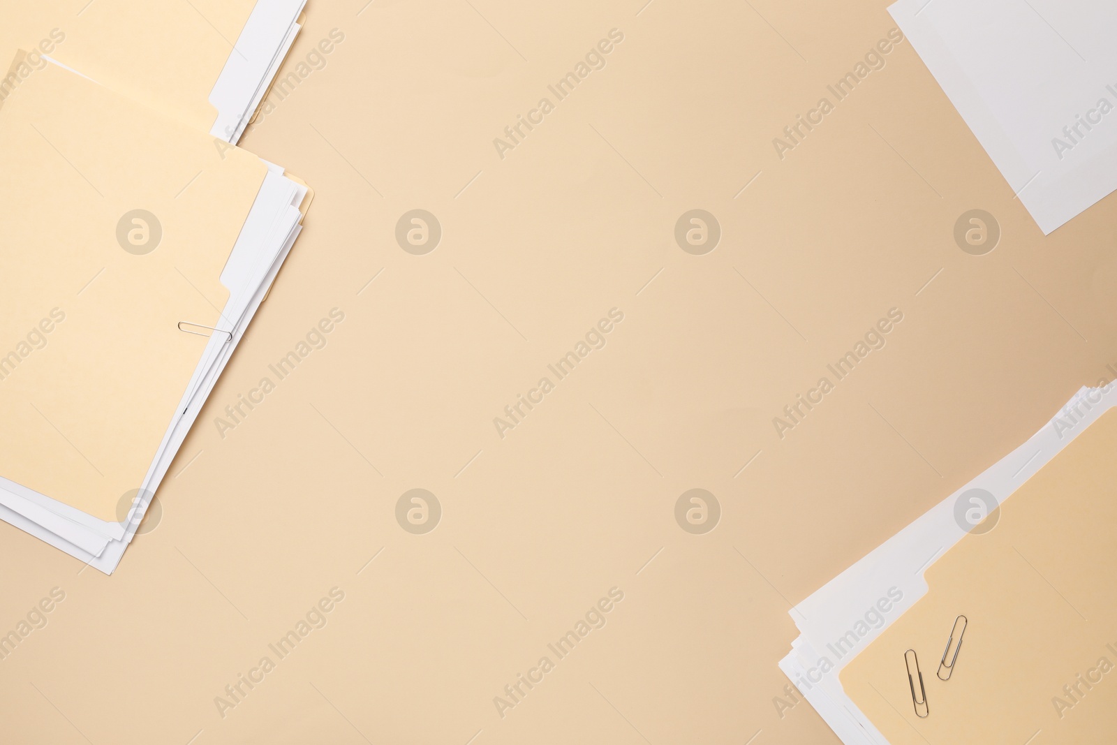 File folders with papers on beige background, flat lay. Space for text Photo of File folders with papers on beige background, flat lay. Space for text