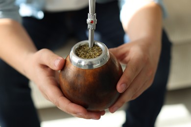 Photo of Man with traditional yerba mate tea at home, closeup