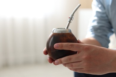 Photo of Man with traditional yerba mate tea at home, closeup. Space for text