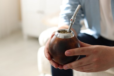 Photo of Man with traditional yerba mate tea at home, closeup. Space for text