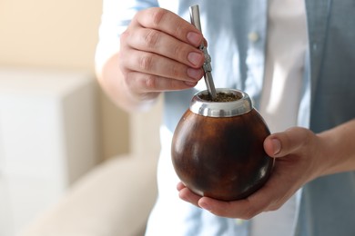 Photo of Man with traditional yerba mate tea at home, closeup