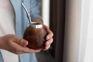 Photo of Man with traditional yerba mate tea at home, closeup. Space for text
