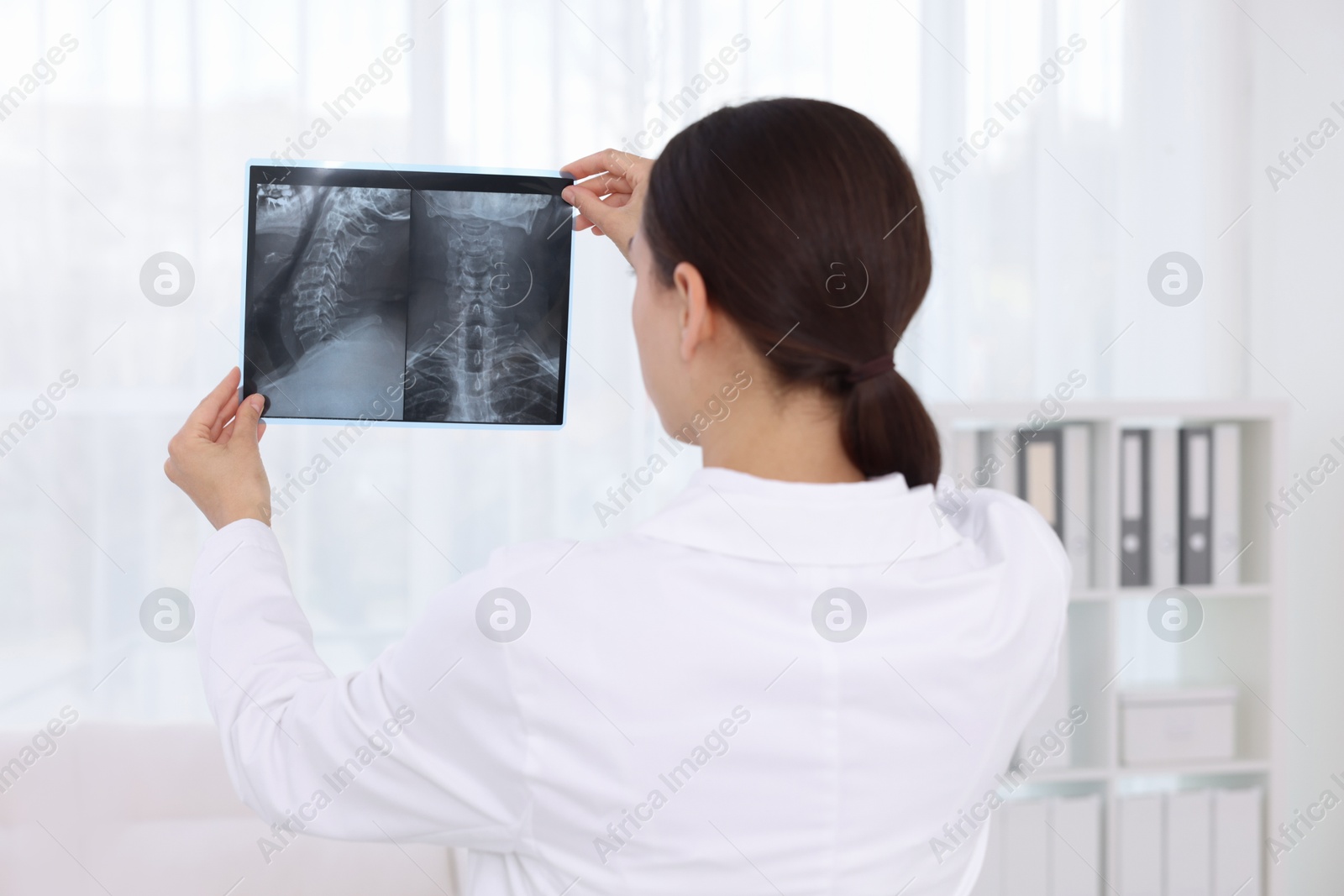 Doctor examining MRI scan in hospital, back view Photo of Doctor examining MRI scan in hospital, back view