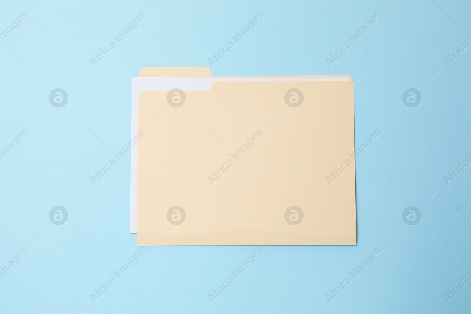 Paper file folder on light blue background, top view Photo of Paper file folder on light blue background, top view