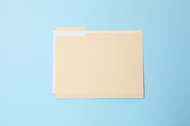 Photo of Paper file folder on light blue background, top view