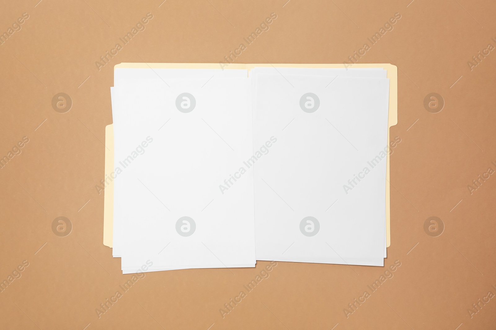 Paper file folder with blank sheets on light brown background, top view Photo of Paper file folder with blank sheets on light brown background, top view