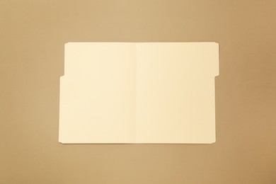 Photo of Paper file folder on light brown background, top view