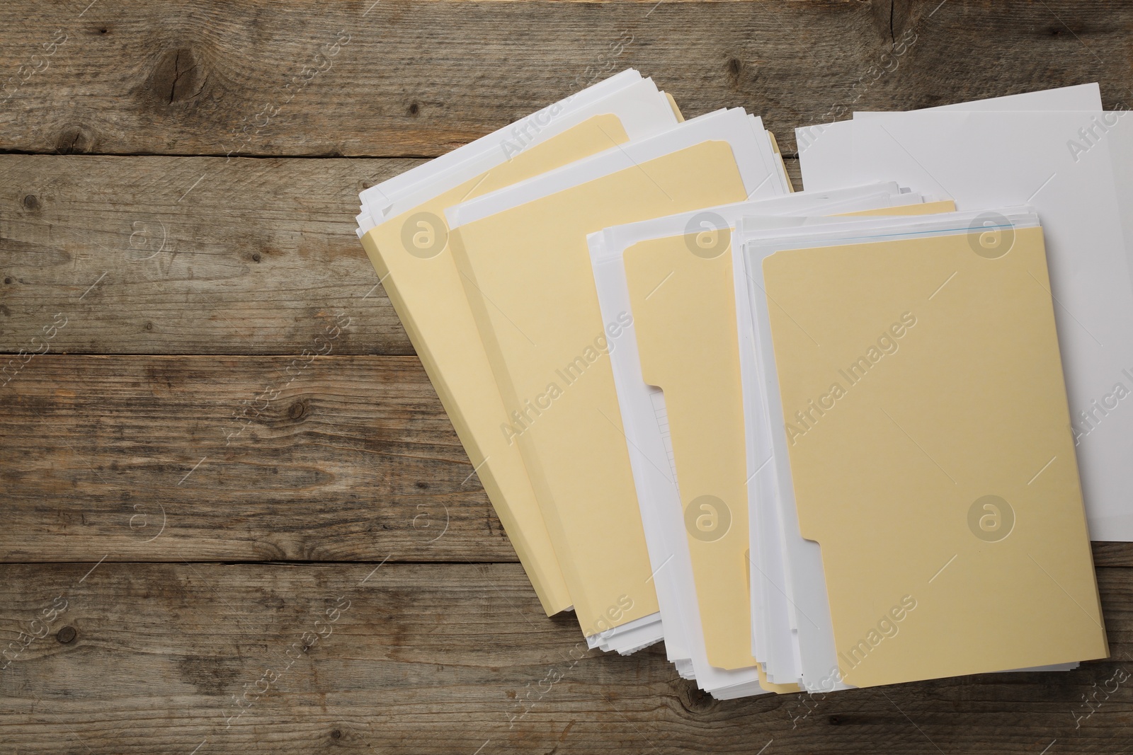 File folders with papers on wooden table, flat lay. Space for text Photo of File folders with papers on wooden table, flat lay. Space for text