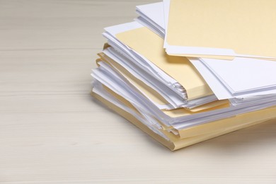Photo of File folders with papers on wooden table, closeup. Space for text