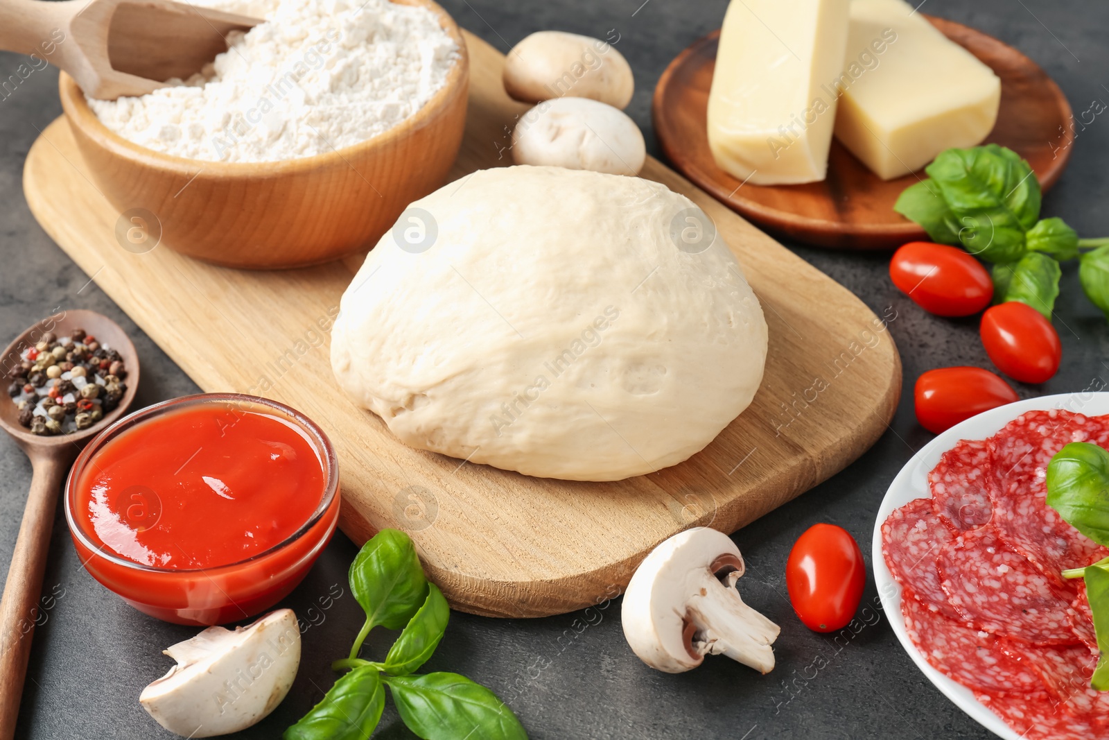 Making pizza. Different ingredients on gray textured table, closeup Photo of Making pizza. Different ingredients on gray textured table, closeup