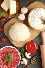 Photo of Making pizza. Different ingredients on gray textured table, flat lay