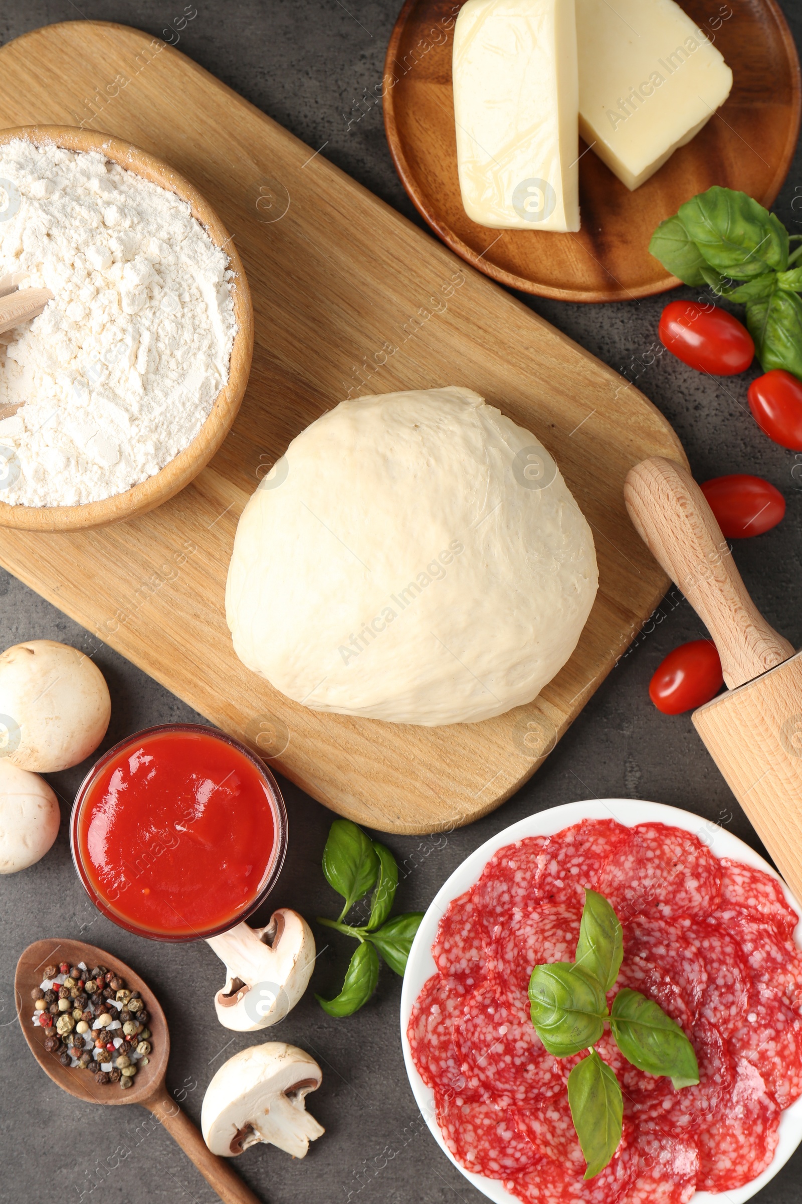 Making pizza. Different ingredients on gray textured table, flat lay Photo of Making pizza. Different ingredients on gray textured table, flat lay