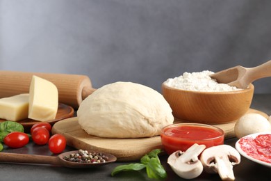 Photo of Making pizza. Different ingredients on gray table, closeup