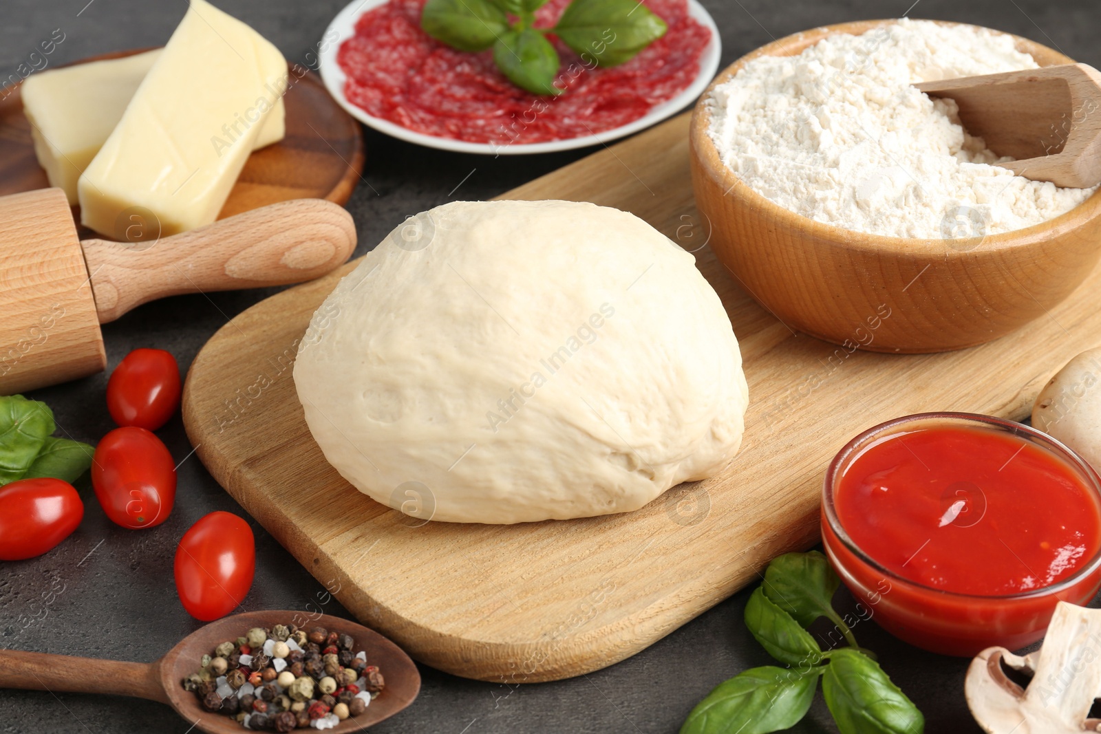 Making pizza. Different ingredients on gray textured table, closeup Photo of Making pizza. Different ingredients on gray textured table, closeup