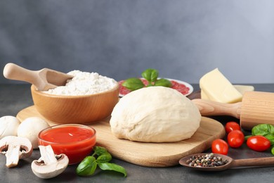 Photo of Making pizza. Different ingredients on gray textured table
