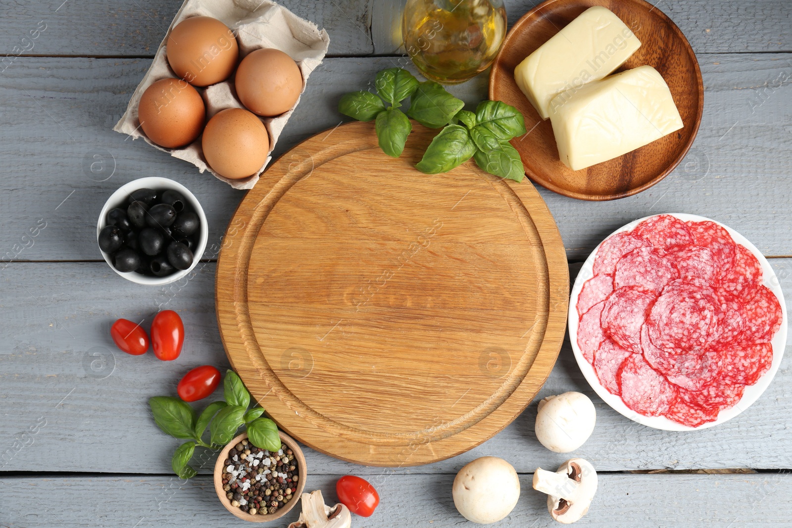 Making pizza. Different ingredients on gray wooden table, flat lay. Space for text Photo of Making pizza. Different ingredients on gray wooden table, flat lay. Space for text