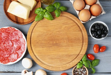 Photo of Making pizza. Different ingredients on gray wooden table, flat lay. Space for text