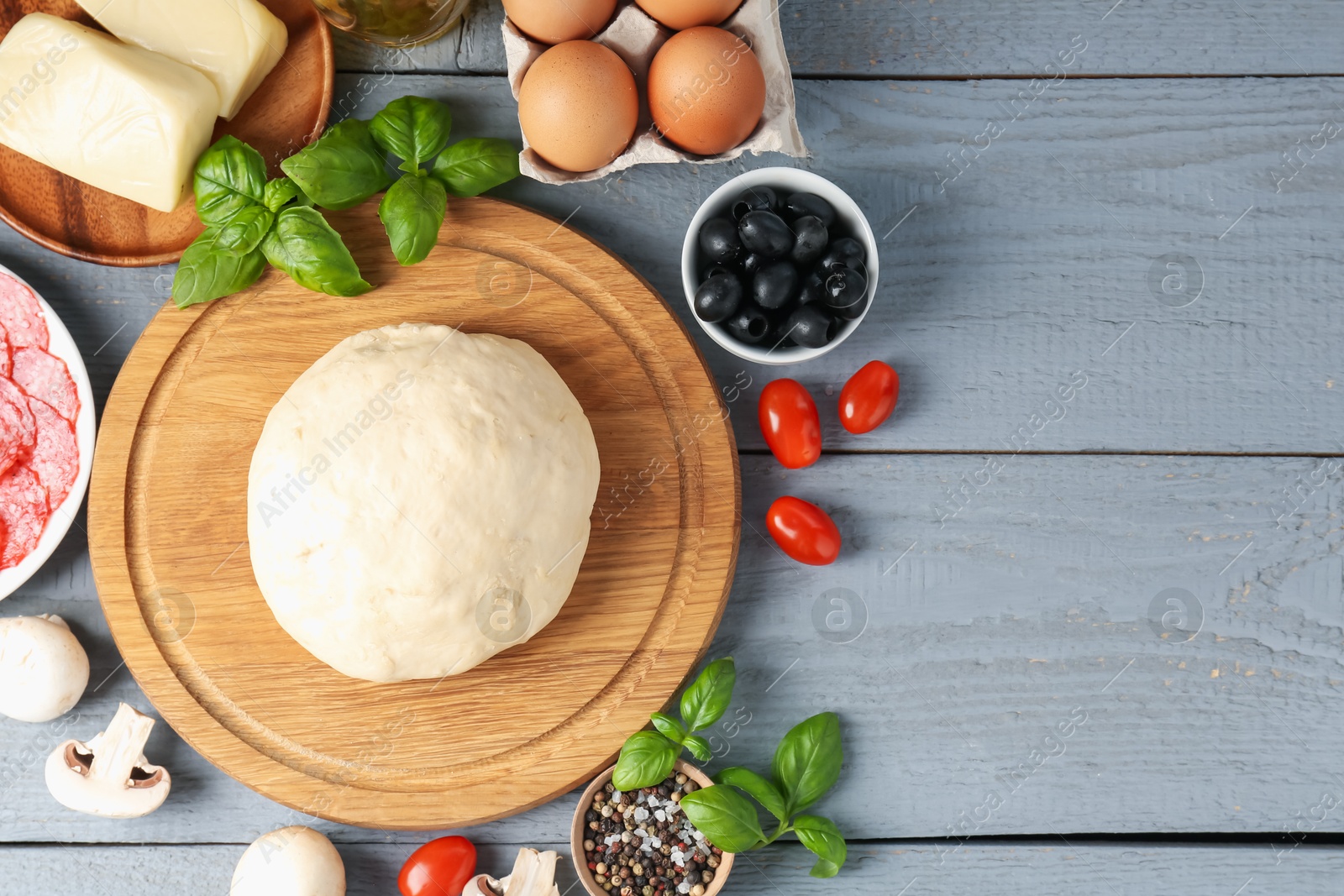 Making pizza. Different ingredients on gray wooden table, flat lay. Space for text Photo of Making pizza. Different ingredients on gray wooden table, flat lay. Space for text