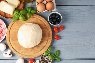 Photo of Making pizza. Different ingredients on gray wooden table, flat lay. Space for text