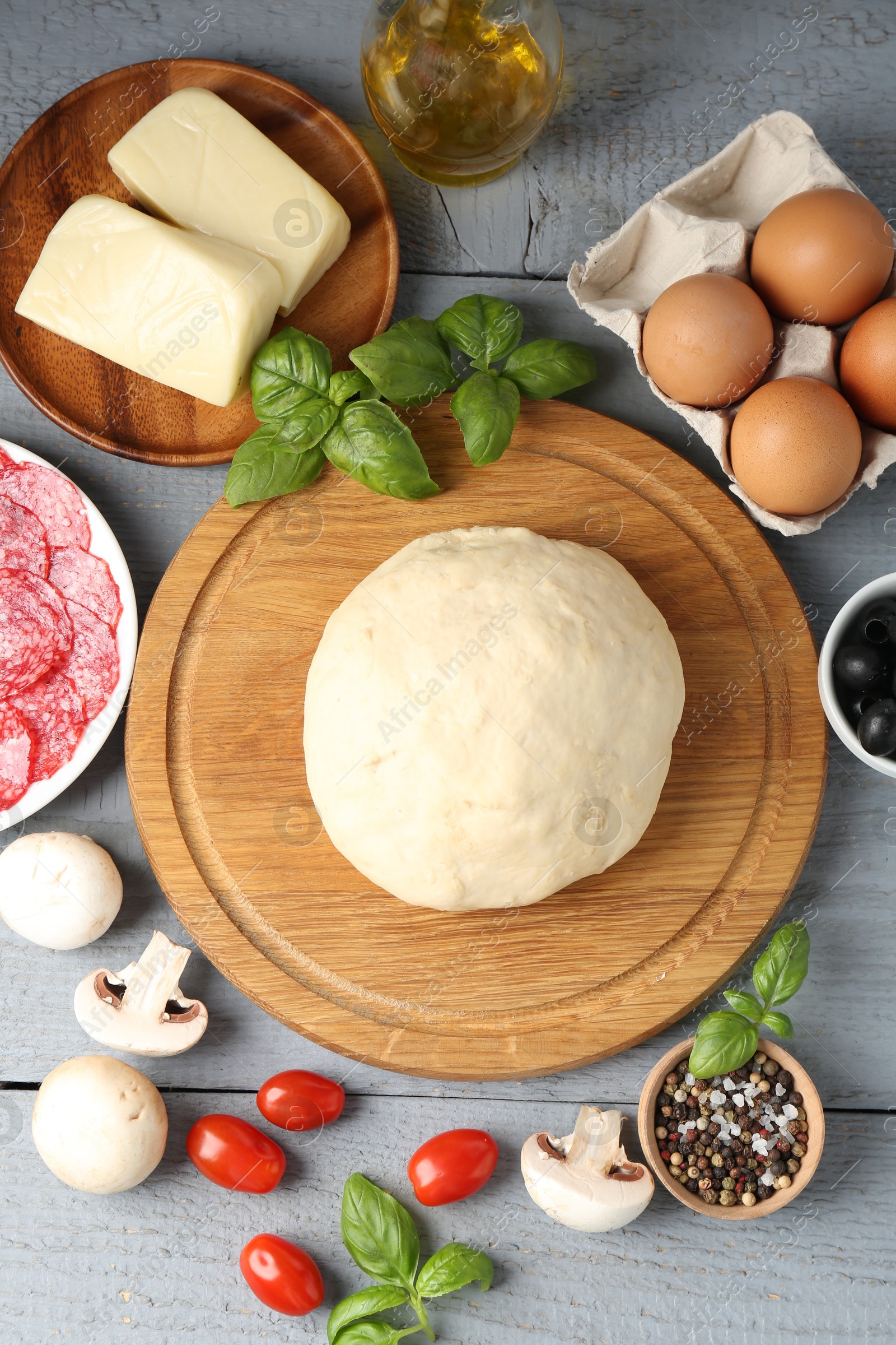 Making pizza. Different ingredients on gray wooden table, flat lay Photo of Making pizza. Different ingredients on gray wooden table, flat lay