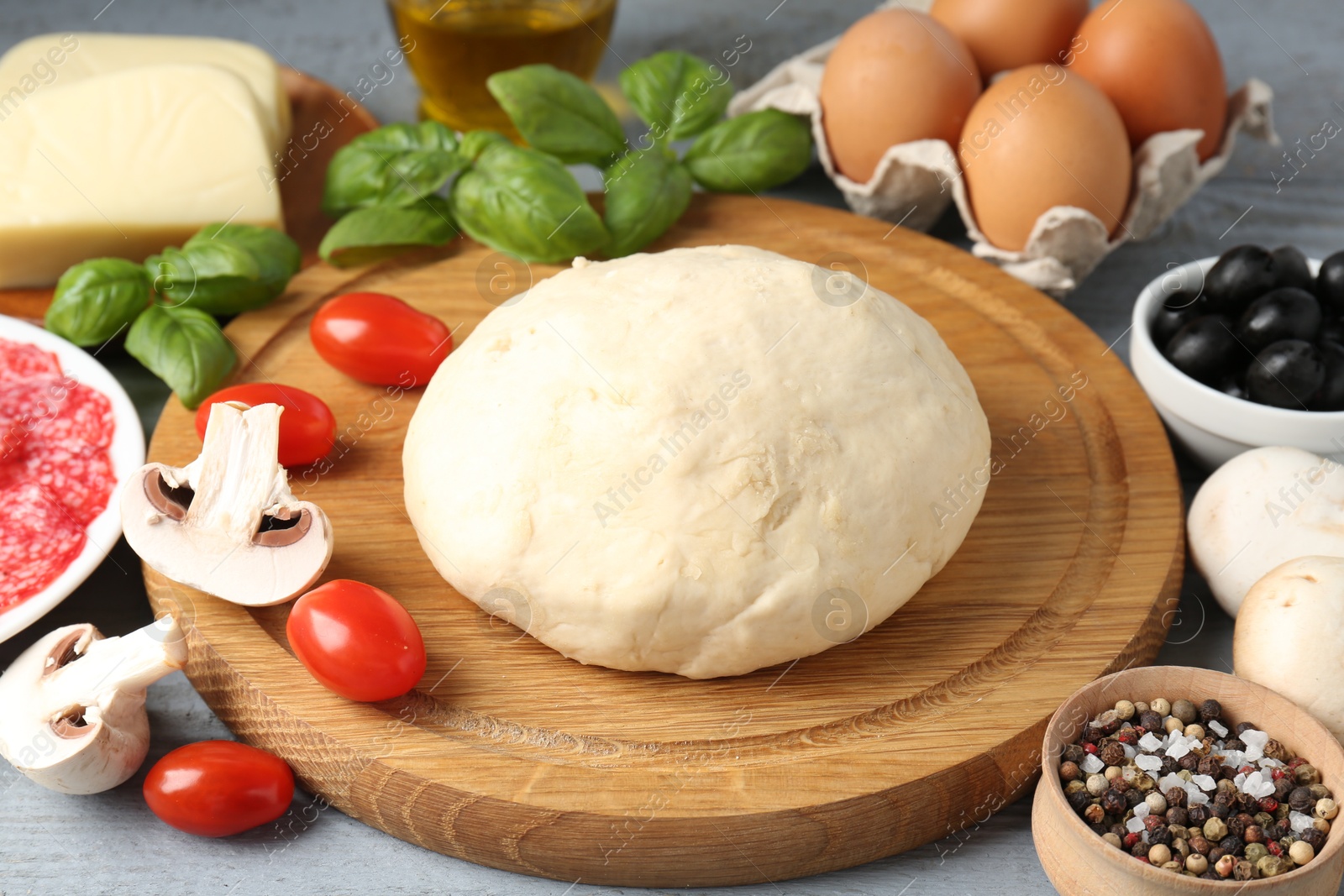 Making pizza. Different ingredients on gray wooden table, closeup Photo of Making pizza. Different ingredients on gray wooden table, closeup