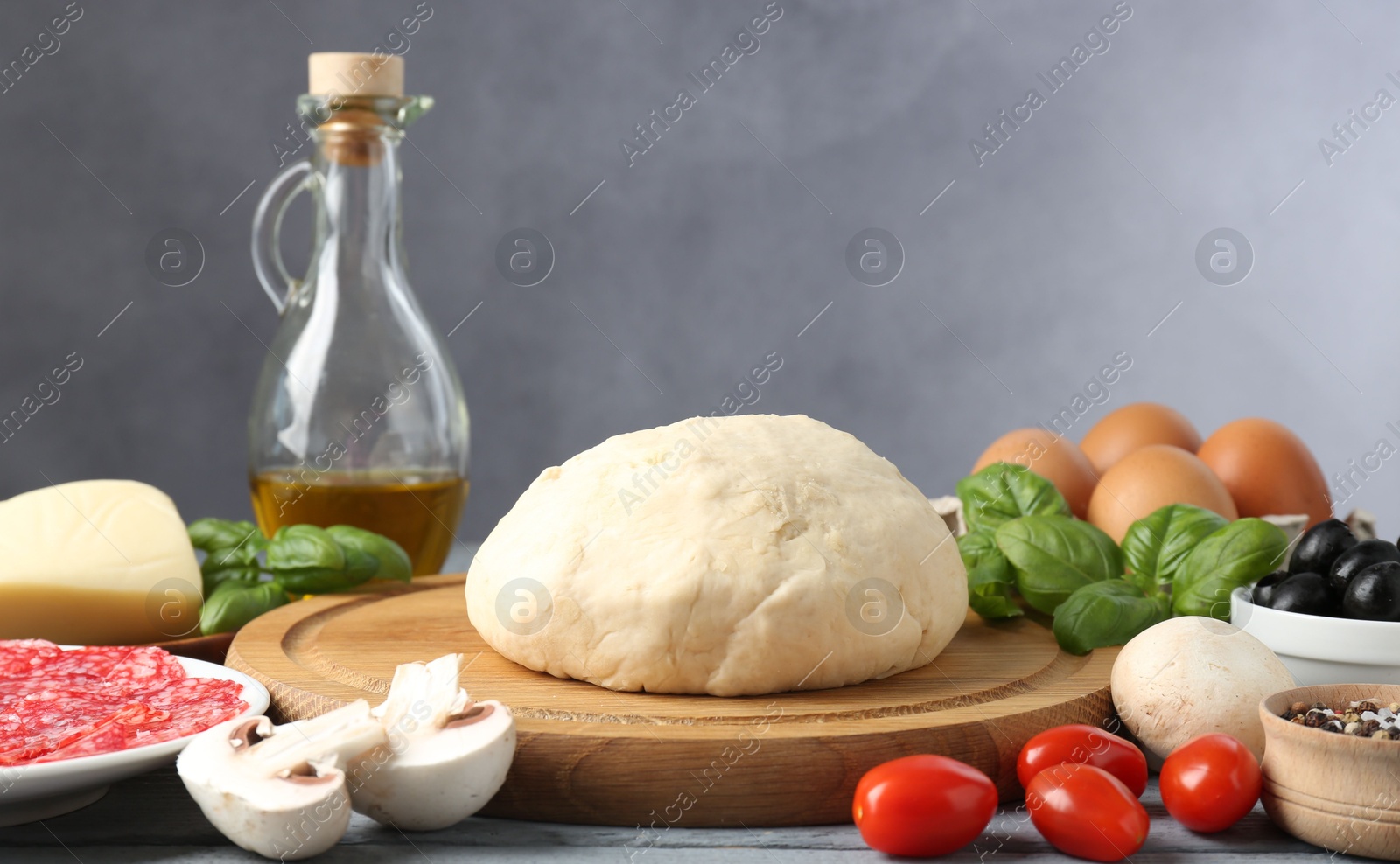 Making pizza. Different ingredients on gray table Photo of Making pizza. Different ingredients on gray table