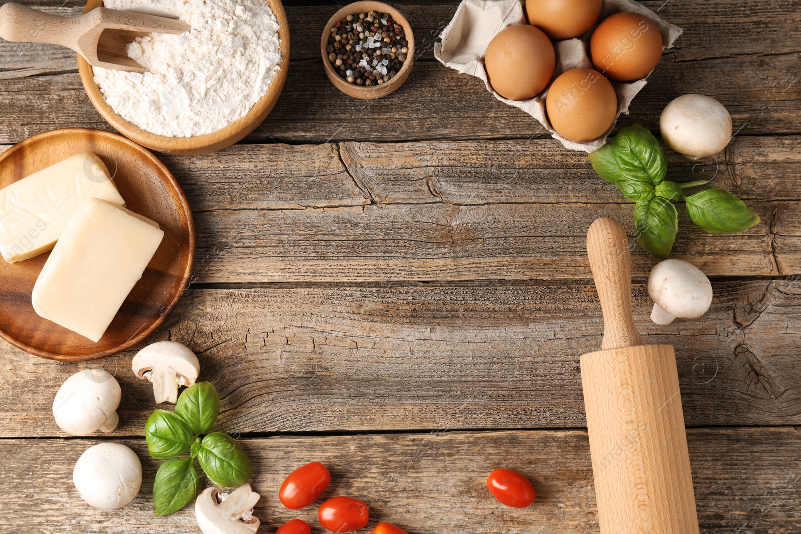 Making pizza. Different ingredients on wooden table, flat lay. Space for text Photo of Making pizza. Different ingredients on wooden table, flat lay. Space for text