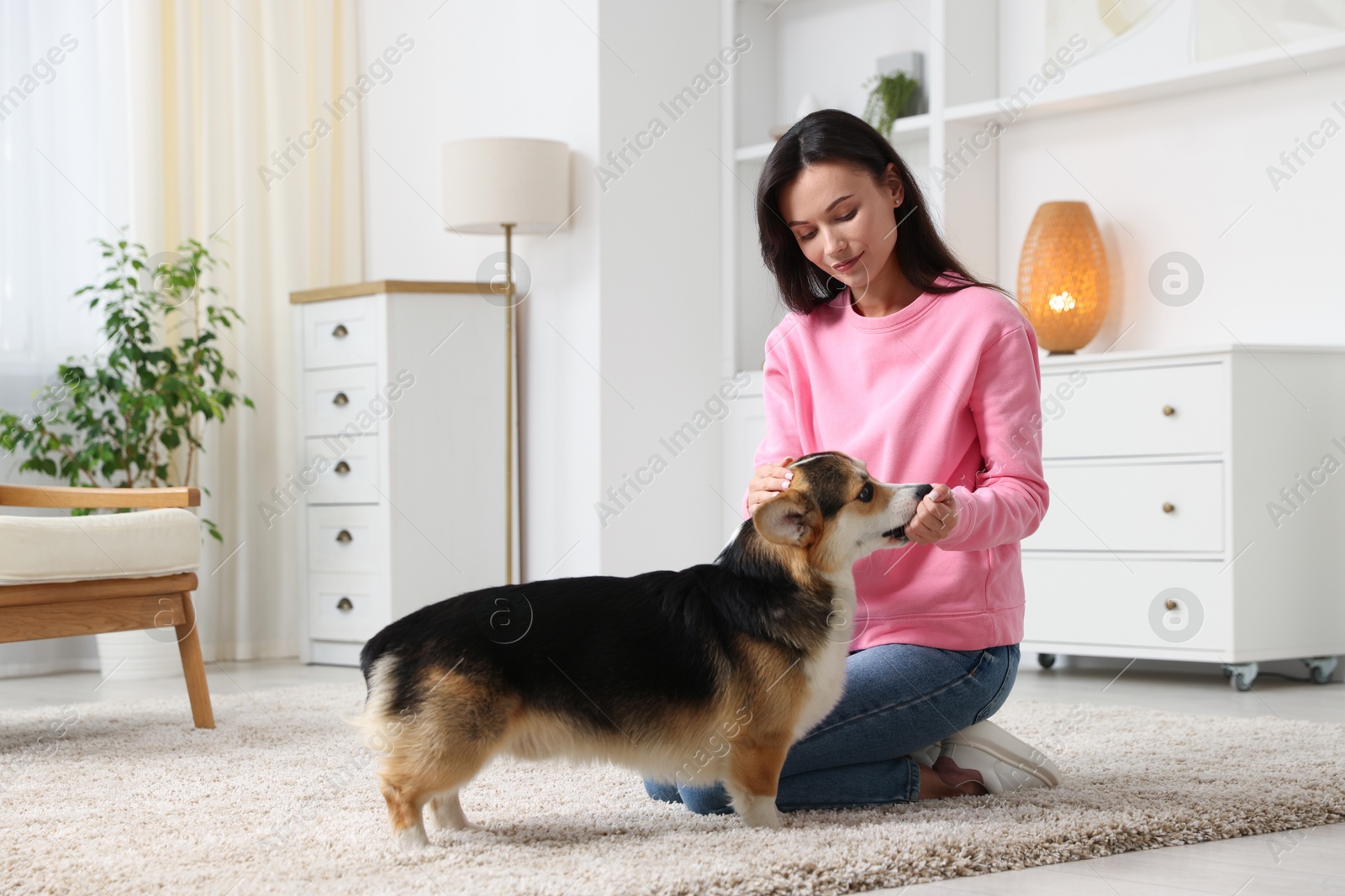 Woman training her dog on floor at home Photo of Woman training her dog on floor at home