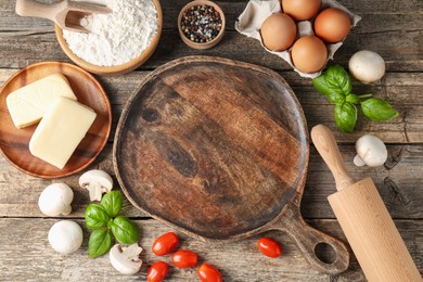 Photo of Making pizza. Different ingredients on wooden table, flat lay. Space for text