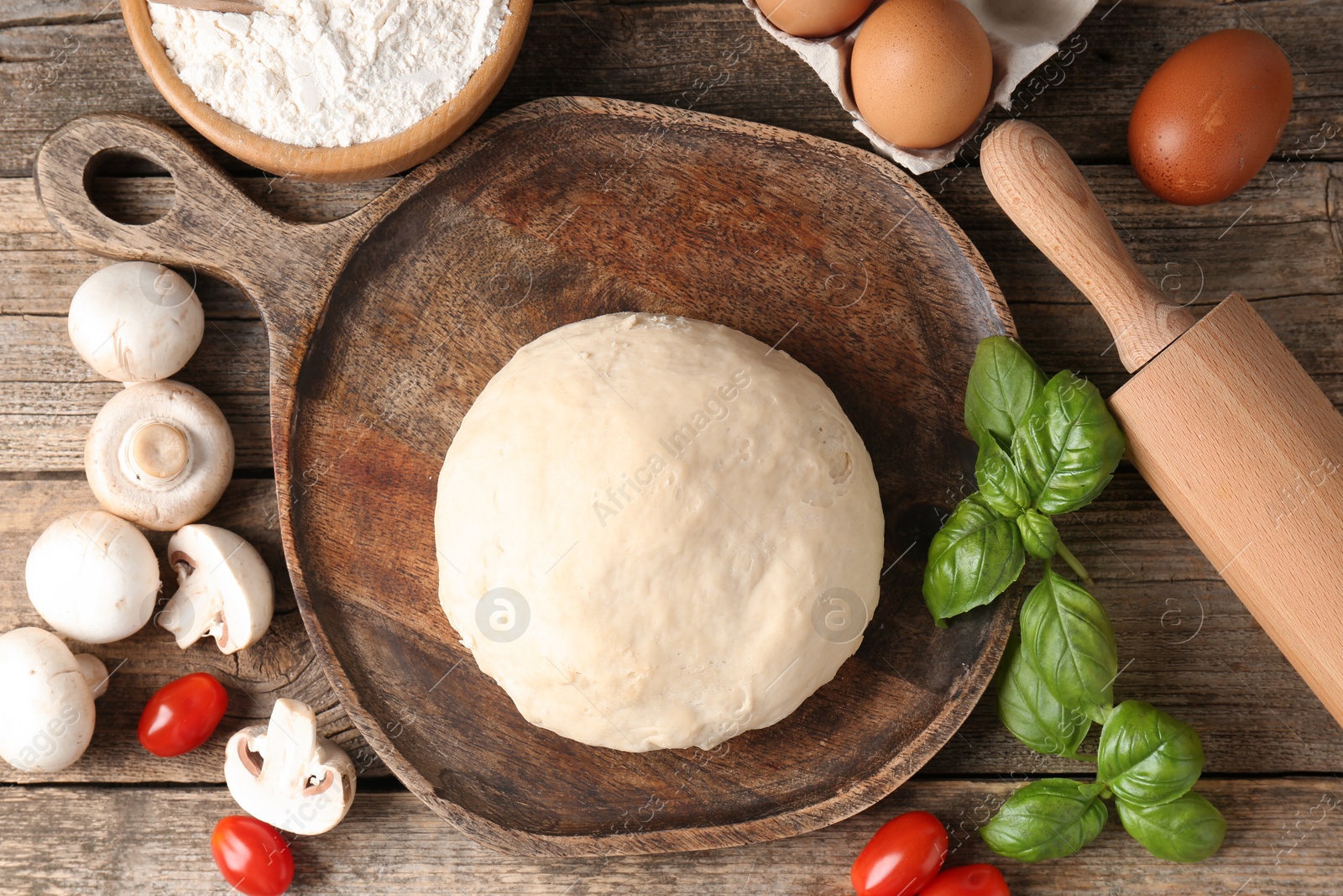 Making pizza. Different ingredients on wooden table, flat lay Photo of Making pizza. Different ingredients on wooden table, flat lay
