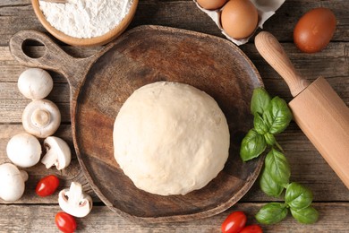 Photo of Making pizza. Different ingredients on wooden table, flat lay