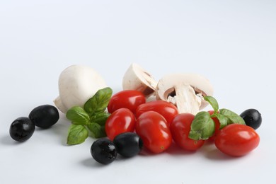 Photo of Making pizza. Different ingredients isolated on white
