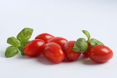 Photo of Fresh tomatoes and basil for pizza isolated on white