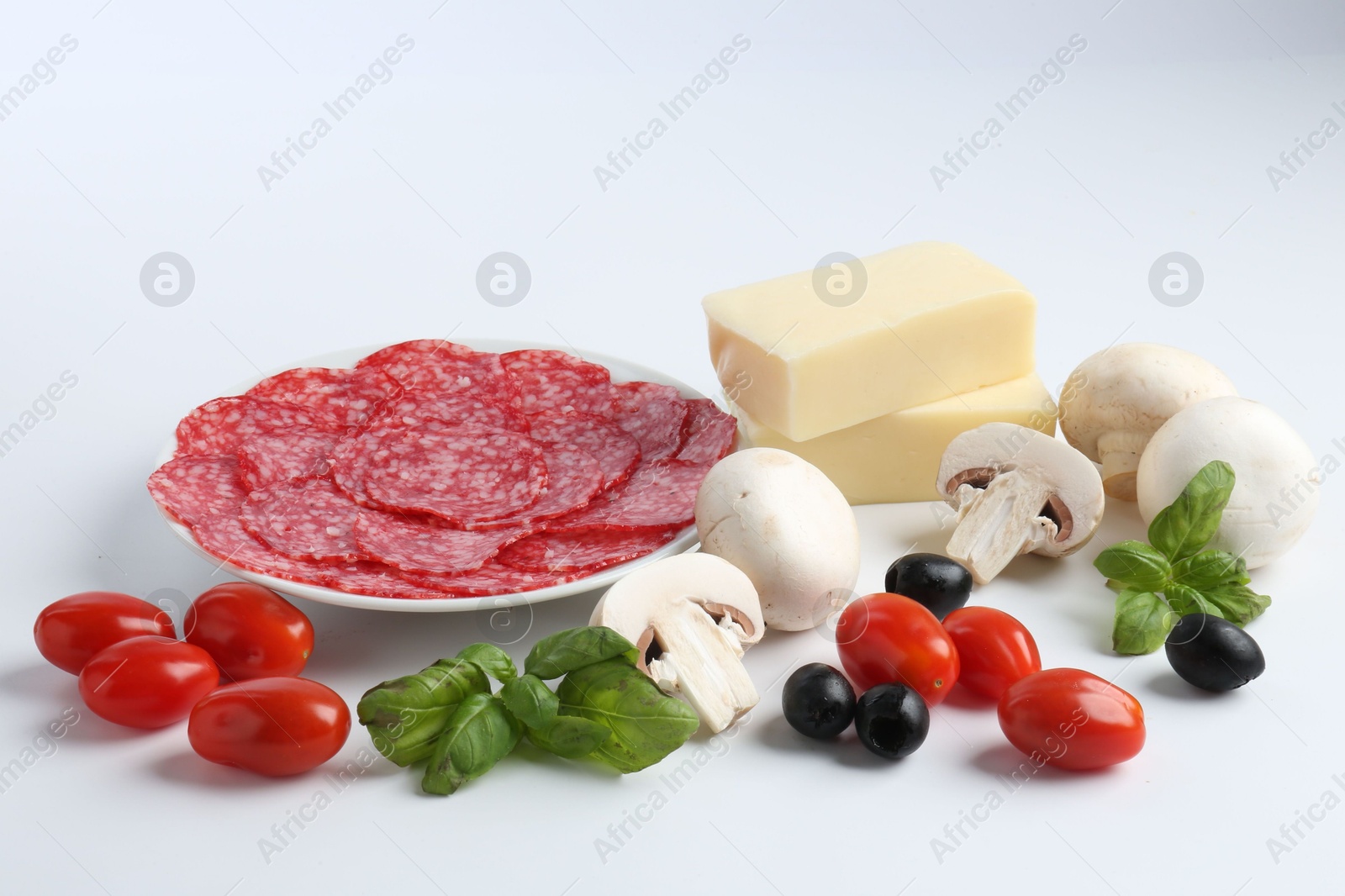 Making pizza. Different ingredients isolated on white Photo of Making pizza. Different ingredients isolated on white