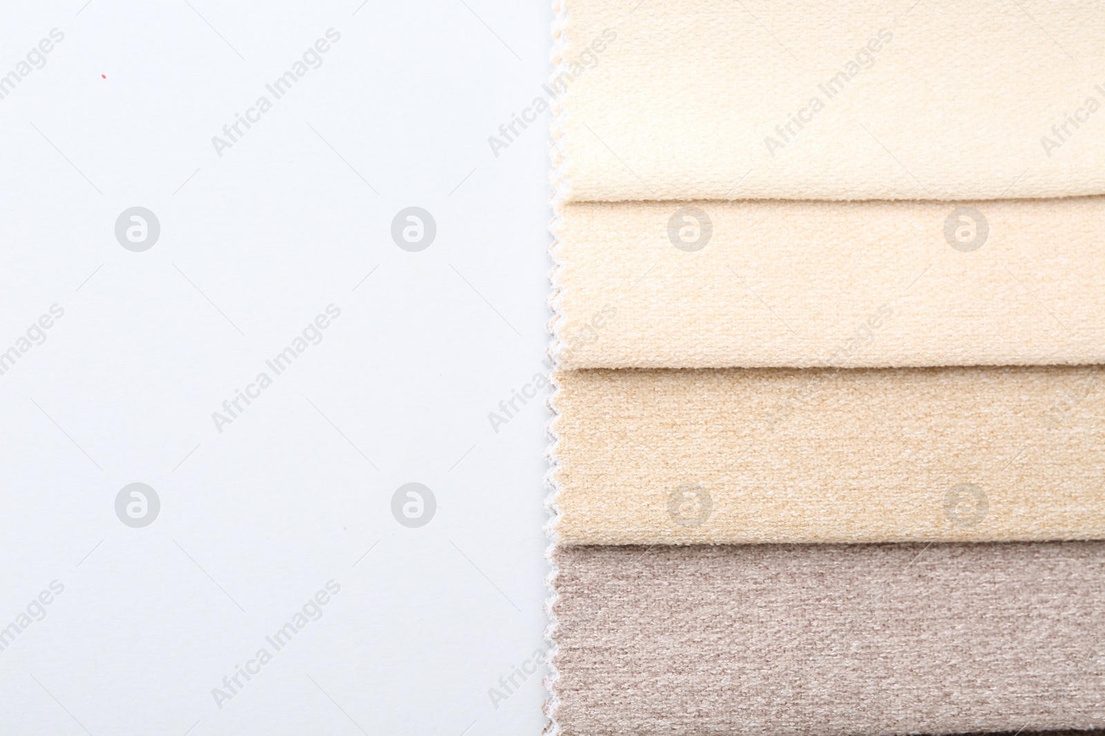 Samples of different fabrics on white background, top view. Space for text Photo of Samples of different fabrics on white background, top view. Space for text