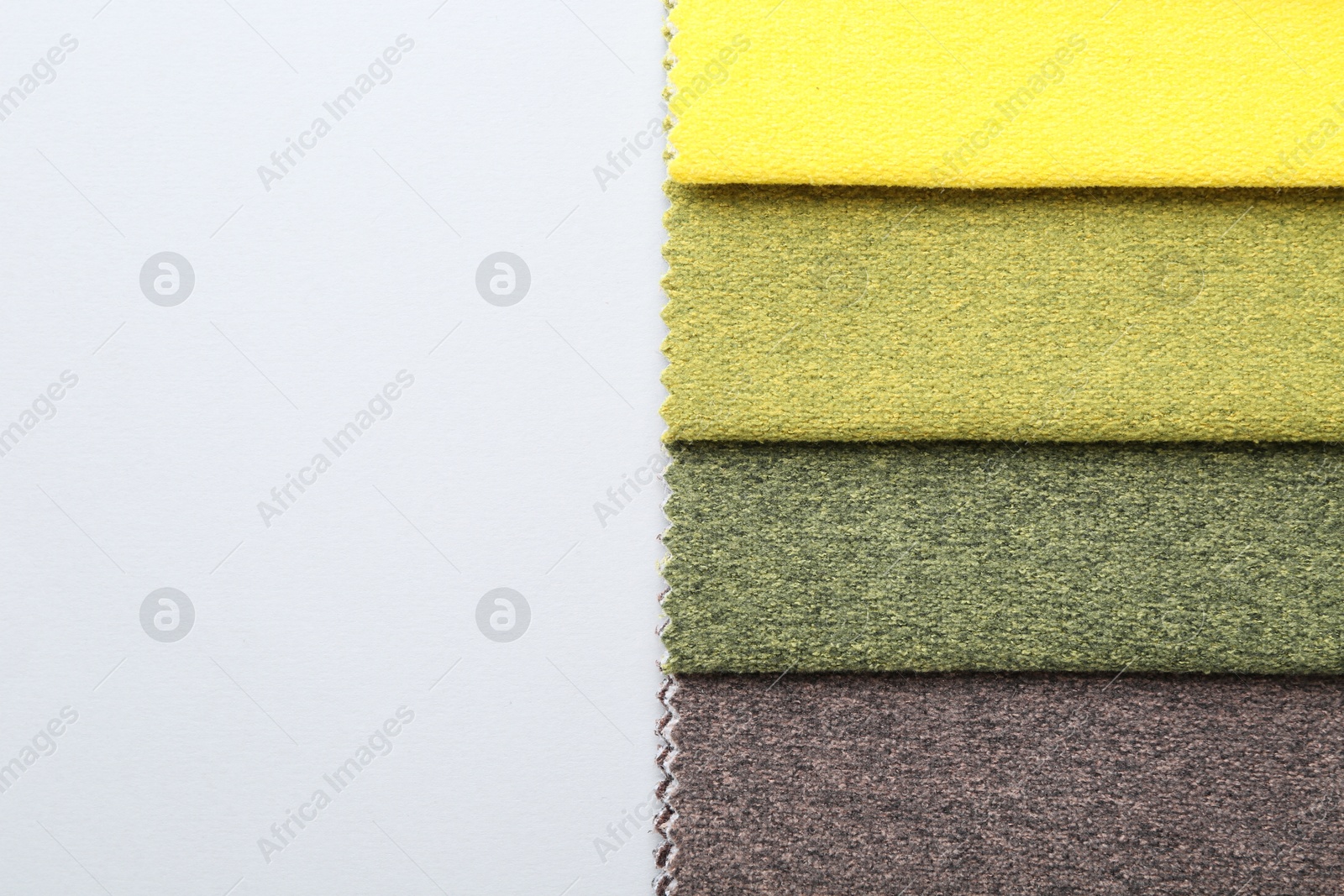 Samples of different fabrics on white background, top view. Space for text Photo of Samples of different fabrics on white background, top view. Space for text