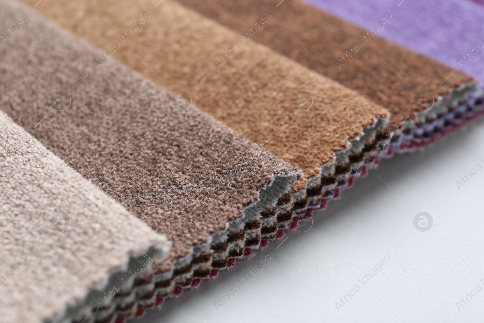 Samples of different fabrics on white background, closeup. Space for text Photo of Samples of different fabrics on white background, closeup. Space for text