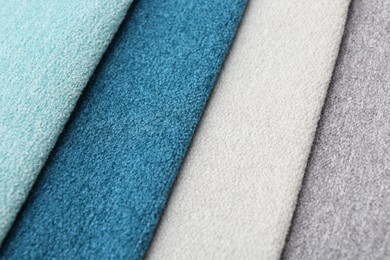 Photo of Samples of different fabrics as background, closeup