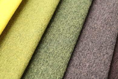 Photo of Samples of different fabrics as background, closeup