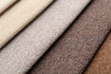 Photo of Samples of different fabrics as background, closeup