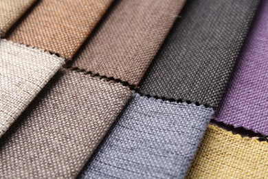 Photo of Samples of different fabrics as background, closeup