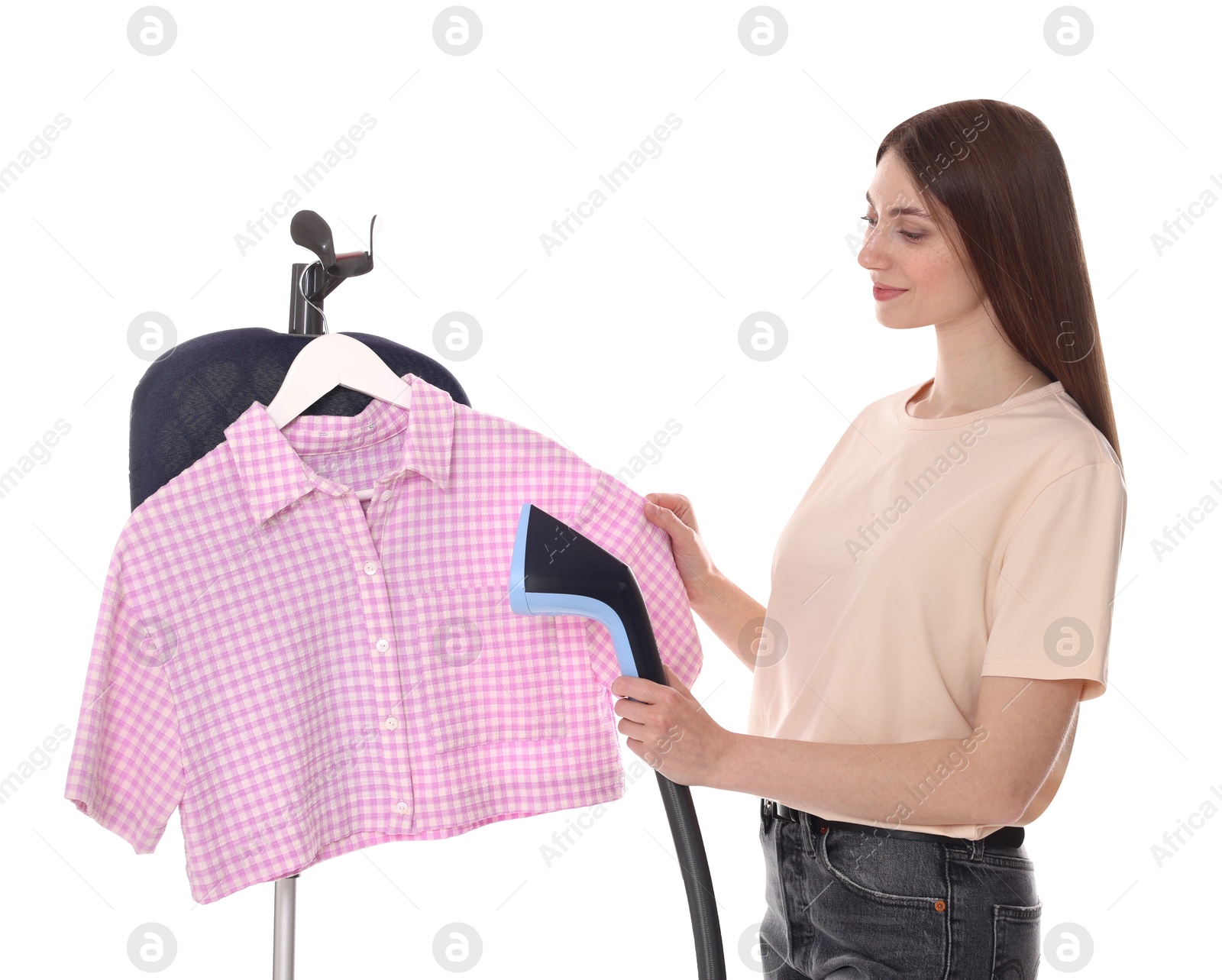 Photo of Woman steaming shirt on stand against white background