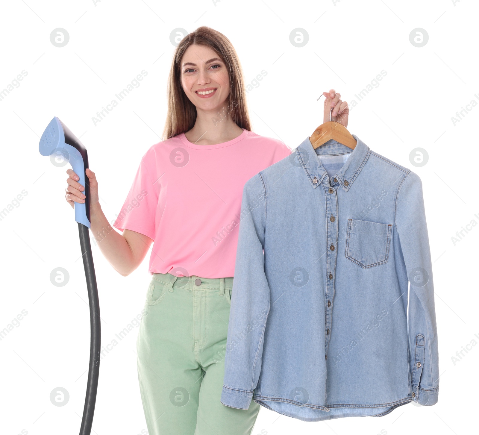 Smiling woman with clothes steamer and shirt on white background Photo of Smiling woman with clothes steamer and shirt on white background