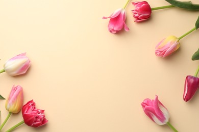Photo of Beautiful tulips on beige background, flat lay. Space for text
