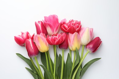 Photo of Beautiful tulips on white background, flat lay