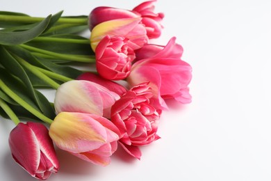 Photo of Beautiful tulips on white background, closeup. Space for text